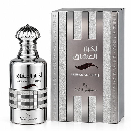 A bottle of Akhbar Al Ushaq perfume next to its retail box, both in silver and gray tones with Arabic and English text.