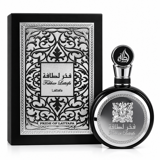 A bottle of Fath al-Haqqa by Laftafa perfume next to its ornate black and silver presentation box, set against a plain white background.