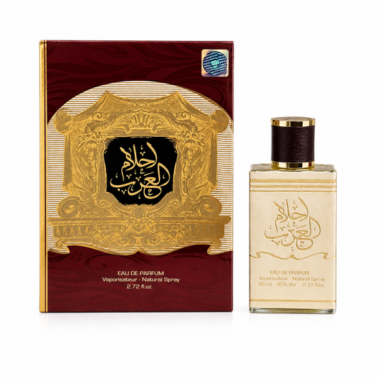 A bottle of Arabic perfume next to its ornate box. The packaging features a deep maroon-red background with a large gold frame and black Arabic calligraphy in the center.