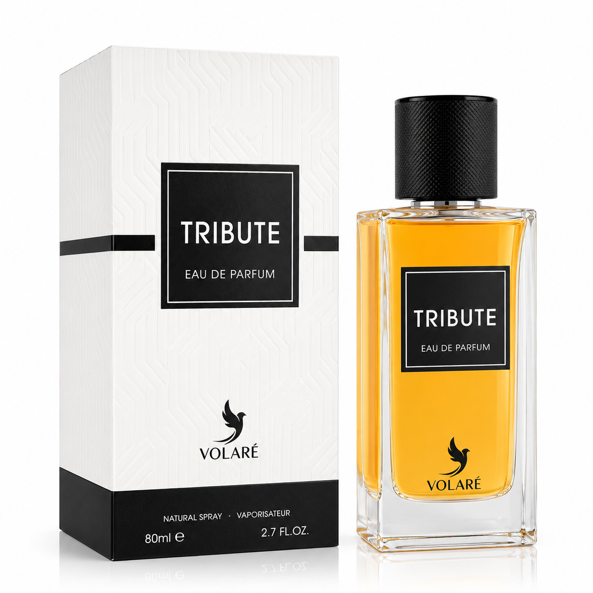 A bottle of VOLARÉ Tribute Eau de Parfum with golden-yellow liquid and a black cap, shown next to its white and black packaging box on a clean white background.